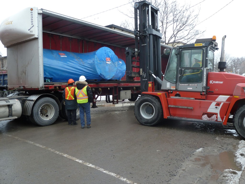 The accelerator portion in its shipping container being transferred into our new building. (Photo: Dr. Liam Kieser)