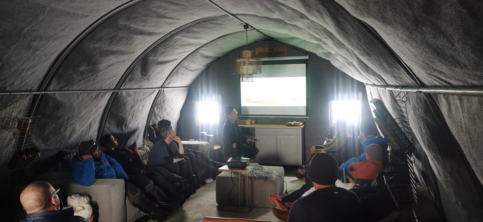 Figure 8. Our team is presenting their work at the base camp at Wolf’s Fang Runway for tourists and the White Desert team. [Credit: Steven Giordano].