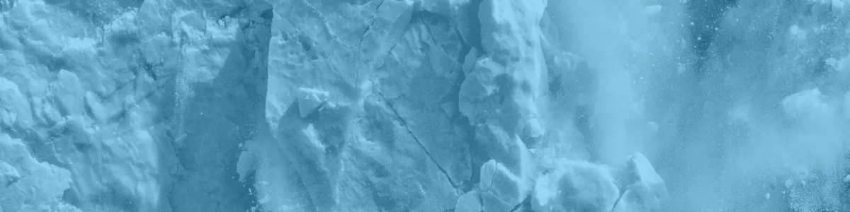 Tinted detail of a photo: Huge block of blue and white ice collapsing from a glacier front, shattering into fragments and throwing up a large white splash where it hits the dark water.