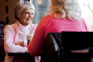 A conversation between a person and a smiling elder lady.