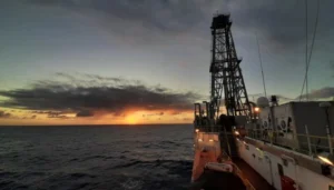 Photo of sunset behind the drilling vessel JOIDES resolution