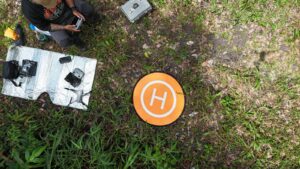 This image shows a drone operator guiding a drone to its landing spot.