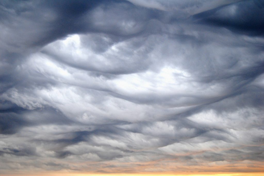 'Nimbostratus painting the sky'. Credit: y María Burguet (distributed via imaggeo.egu.eu). This photo was taken in Valencia (Spain) during a storm formation. Nimbostratus are described as a grey cloud cover with a veiled appearance due to the precipitation (liquid or solid) holded within them. They are formed when a large layer of relatively warm and humid air ascend above a cold air mass. Together with the Altostratus, it is the core of a warm front. 