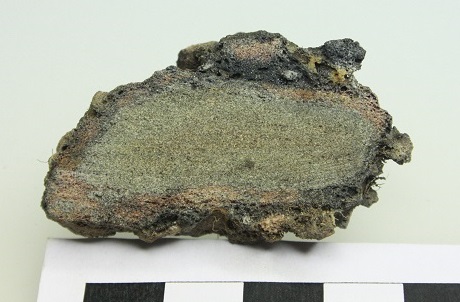 A block from the Wincobank enclosure wall in Sheffield, UK. This piece shows the typical feature where fine grained glassy material is welded to the larger, less altered blocks. In detail, this demonstrates that thermal gradients resulting from heating blocks of different sizes play an important role in determining which blocks melt and weld, and which blocks do not. (Credit: Fabian Wadsworth)