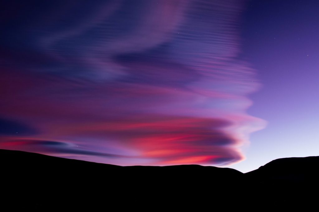 lenticular clouds with purple-pink sky by Stephen Paul Michalchuk