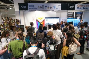The image depicts a small crowd attending a quiz at the EDI booth during EGU26.