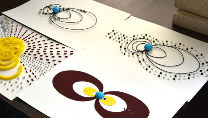 This image shows four tactile images created to share space weather phenomena with blind and visually impaired learners. The image shows a representation of the magnetosphere (a small blue ball with black concentric circles surrounded by dots to the left and right, the ones on the left are smaller), aurora formation (a small blue ball with black concentric circles to the left and right with dots on the circles) and radiation belts ( a small blue ball with a yellow and brown pair of rings extended evenly to the left and the right). All the images are on a white background.