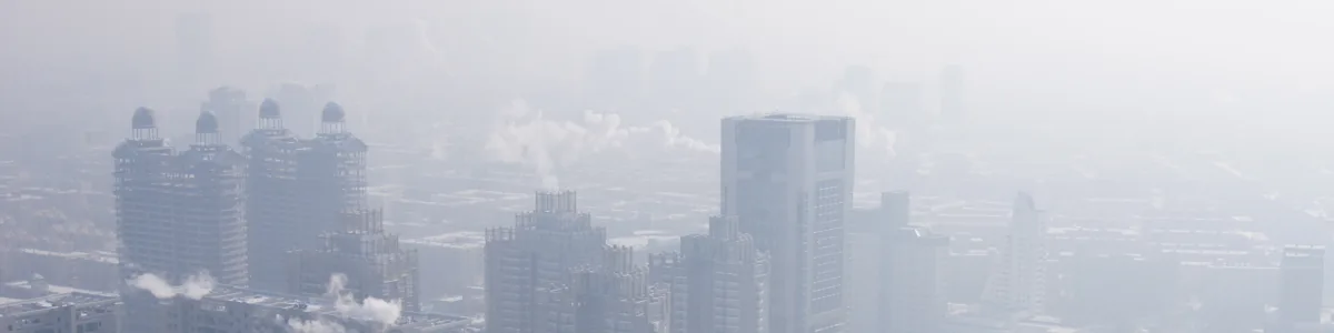 City high-rises fading into thick haze