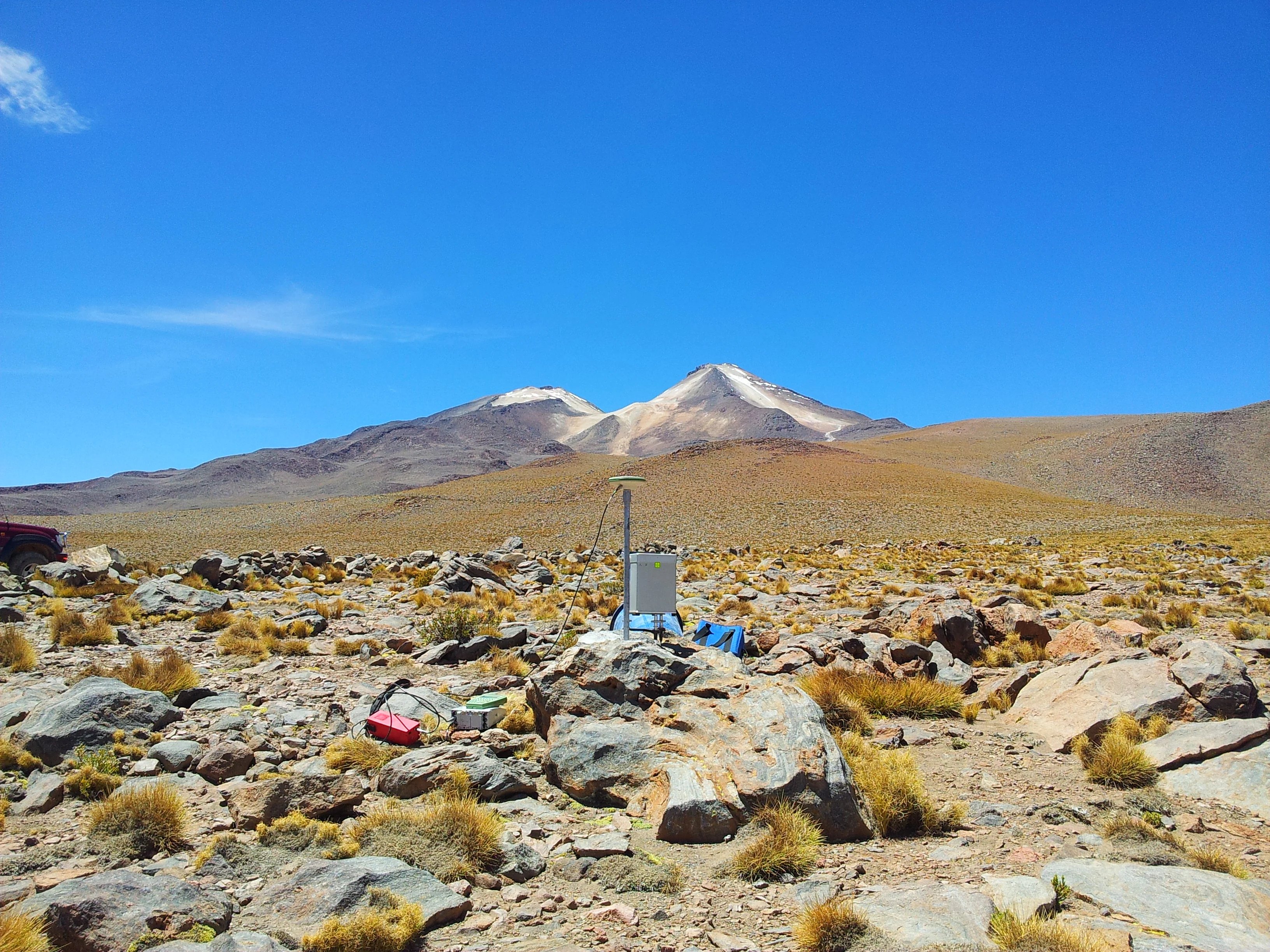 Uturuncu Volcano in the background with a gravimeter and campaign GPS setup in front. Image credit: James Hickey.