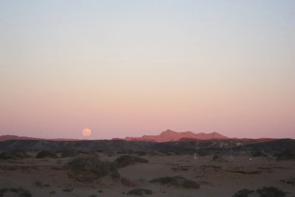 The rising moon over one of the weather stations photographed from the campsite. (Credit: A. Dansie)