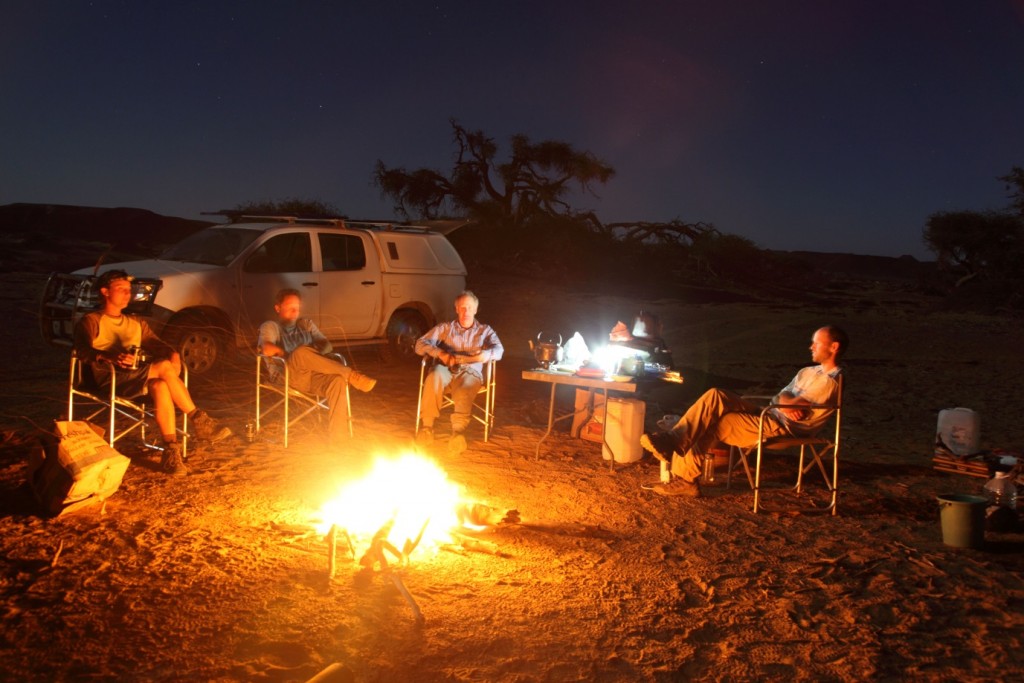 The installation crew enjoying the camp fire after a long hot day in the field. (Credit: R. Washington)