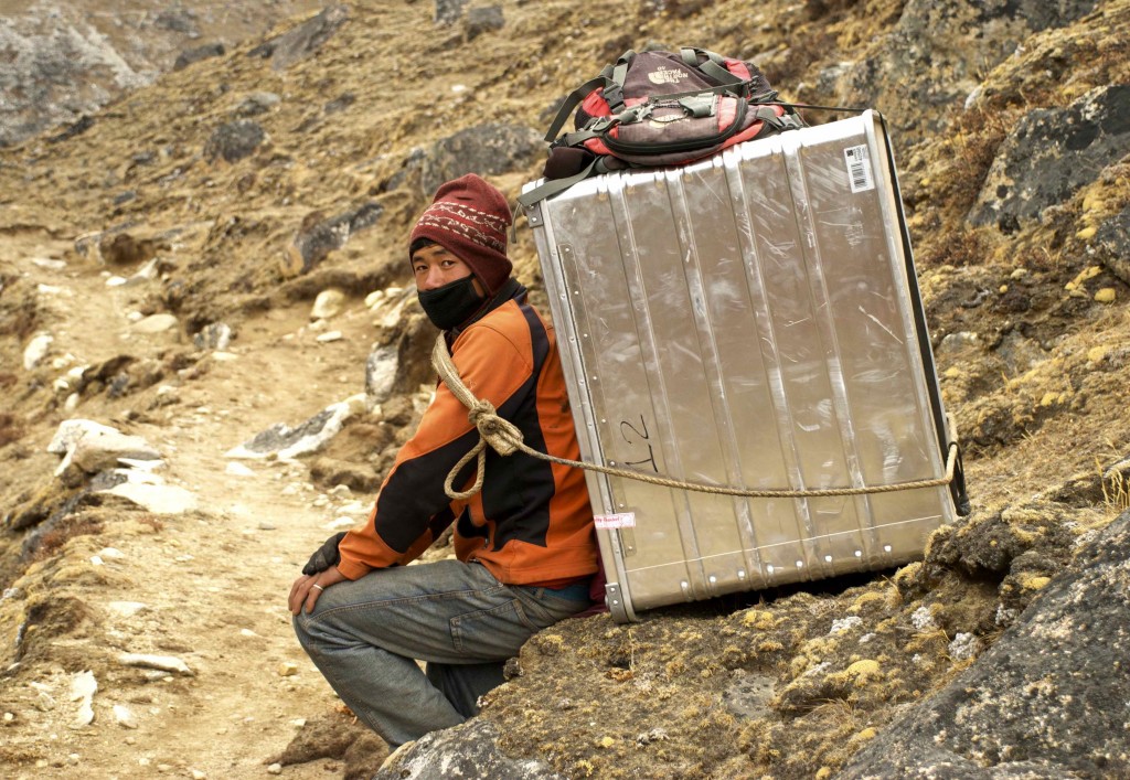 A Nepalese porter carrying new scientific equipment to the Pyramid. 