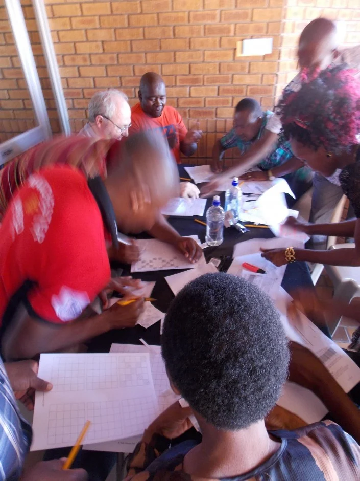 The World Challenge Game in action. ‘Families’ had to colour in sheets to make money for their countries within a time limit. (Credit: Jane Robb)