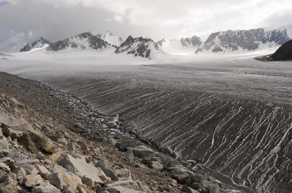 Black Abramov glacier. Before the fall of the Soviet Union, Abramov glacier provided one the the longest continuous glacier mass balance records, dating back to 1968. In 2011, a global research network re-established a monitoring program in cooperation with local partners. The picture highlights the important role of surface albedo in terms of glacier ablation. Credit: Leo Sold (distributed via imaggeo.egu.eu