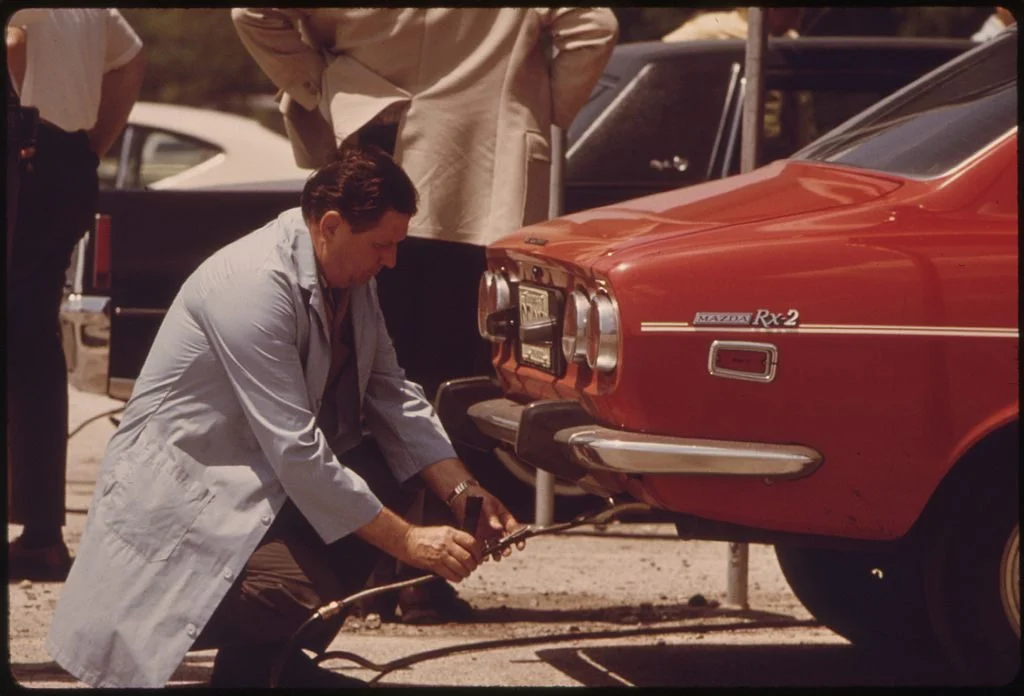 Inspector testing vehicle emissions