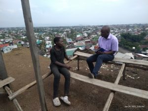 Blaise Nyandwi in discussion with a young boy.