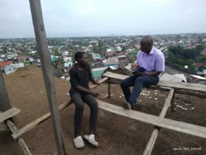 Blaise Nyandwi in discussion with a young boy.