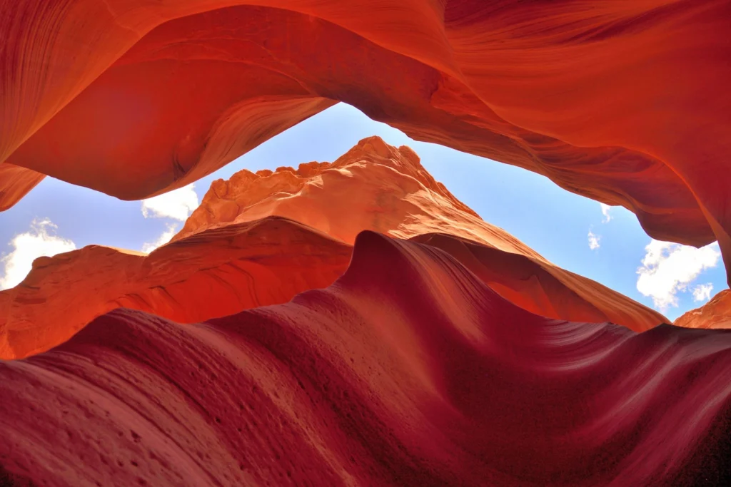 red-orange mountains with a sliver of blue sky by Aude Lavayssière
