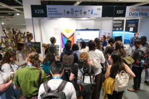 The image depicts a small crowd attending a quiz at the EDI booth during EGU26.