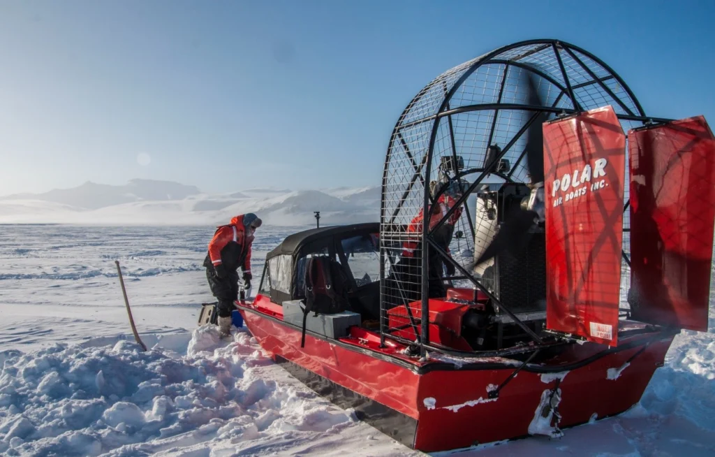 Figure 2: Our polar air-boat for safe and fast transportation on thin sea-ice. During the experiment this bad boy was typically referred to as a gasoline-to-noise converter. In this particular picture the air-boat is pictured on thick sea-ice, hence the use of normal winter clothing instead of marine safety suits. Photo: Jakob Sievers. 
