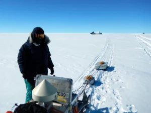 Anna is checking the radar equipment as one of the pisten-bullies is approaching. 