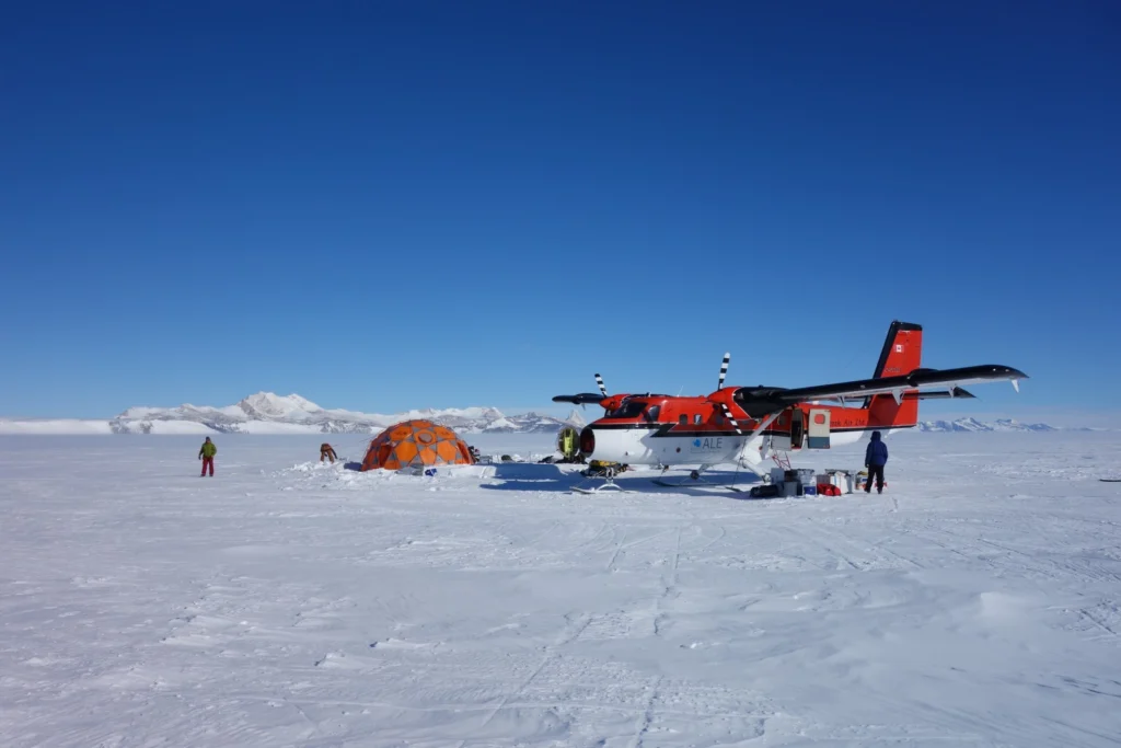 Quickly packing up our camp because the Twin Otter has just arrived to take us back to Union Glacier base. (Credit: H. Millman)