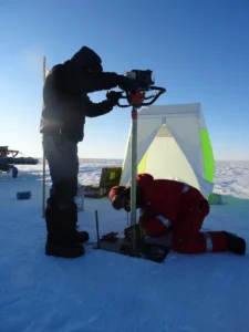 Drilling a firn core requires patience, focus and sturdy gloves. Credit: Anna Winter.