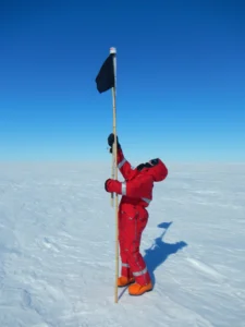 Measuring a the height of a bamboo pole includes high-technology equipment, namely, another bamboo pole with peanut-can and a measurer tape stuck to it. Credit: Nanna B. Karlsson.