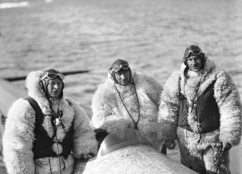 Danish expeditioner Lauge Koch, centre, along with his pilots all dressed in suits made from polar bear. (Credit: The Arctic Institute)