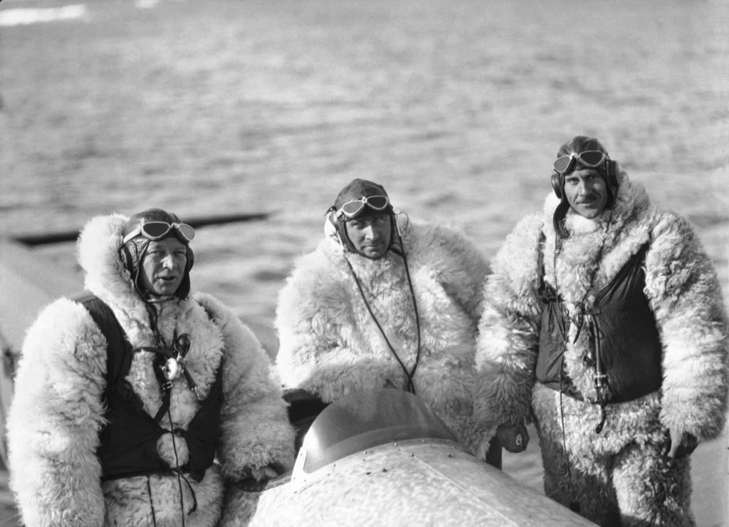 Danish expeditioner Lauge Koch, centre, along with his pilots all dressed in suits made from polar bear. (Credit: The Arctic Institute)