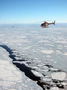 An aerial view of the helicopter taking data of the sea ice below.