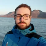 Photo of the author in a blue jacket.