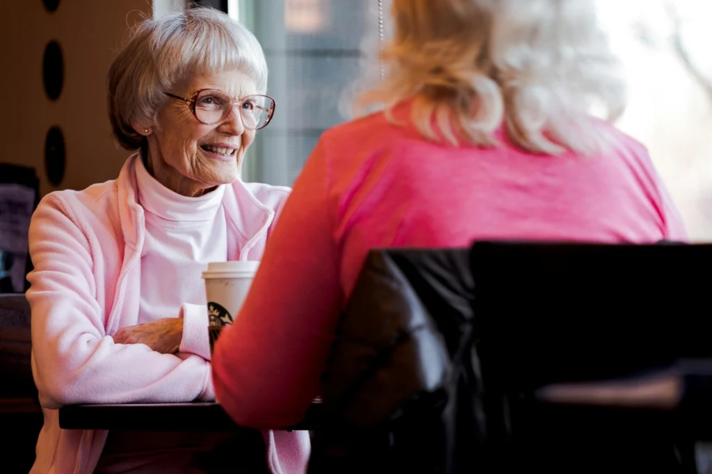A conversation between a person and a smiling elder lady.