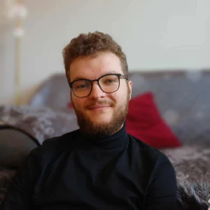 Portrait photograph of Maciej smiling at the camera