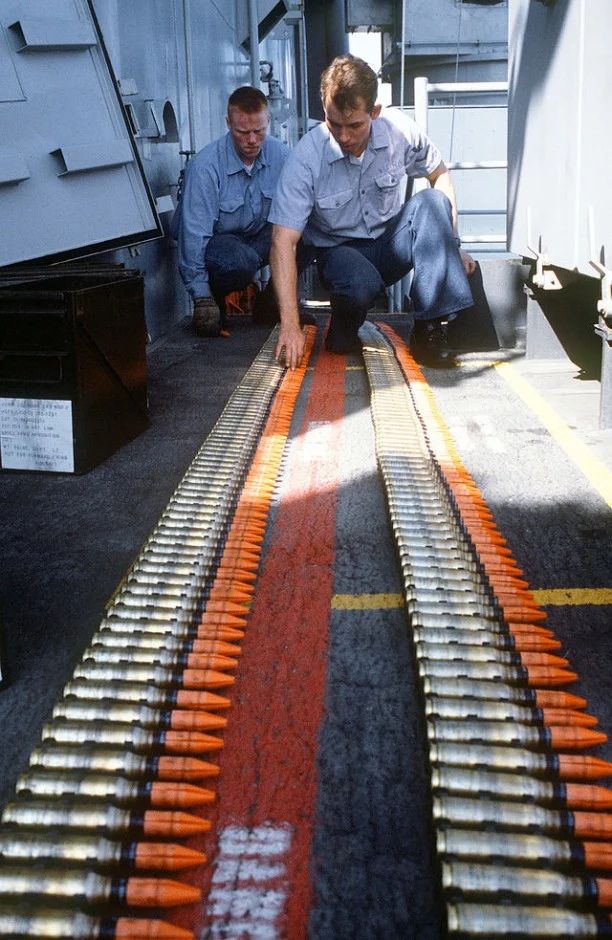 Gunner's mates inspect linked belts of Mark 149 Mod 2 20mm ammunition before loading it into the magazine of a Mark 16 Phalanx close-in weapons system aboard the battleship USS MISSOURI
